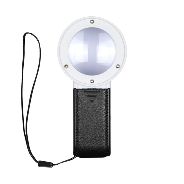 प्रकाश के साथ हाथ आवर्धक ग्लास